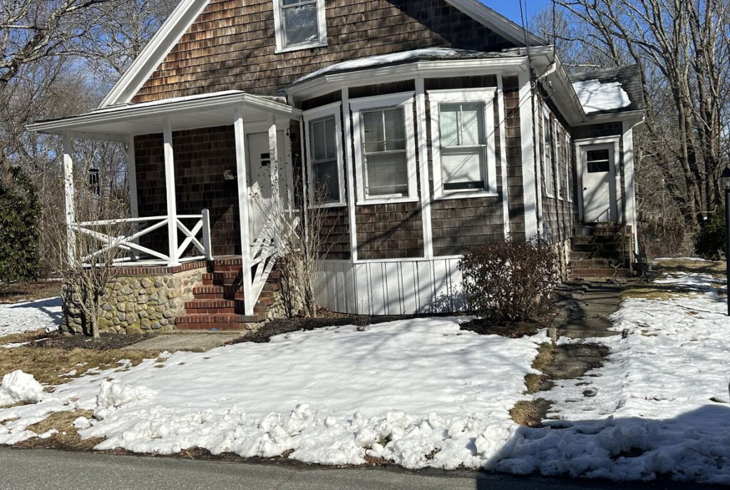 Shingled cape with a front porch in southeastern Massachusetts