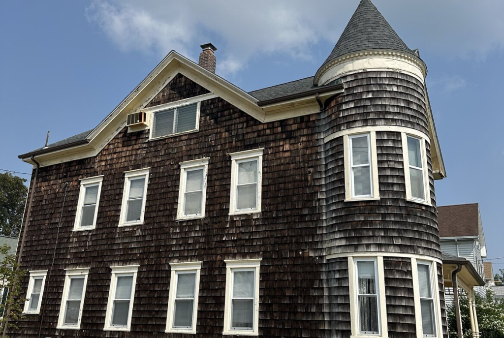 Shingled house with a corner turret in southeastern Massachusetts