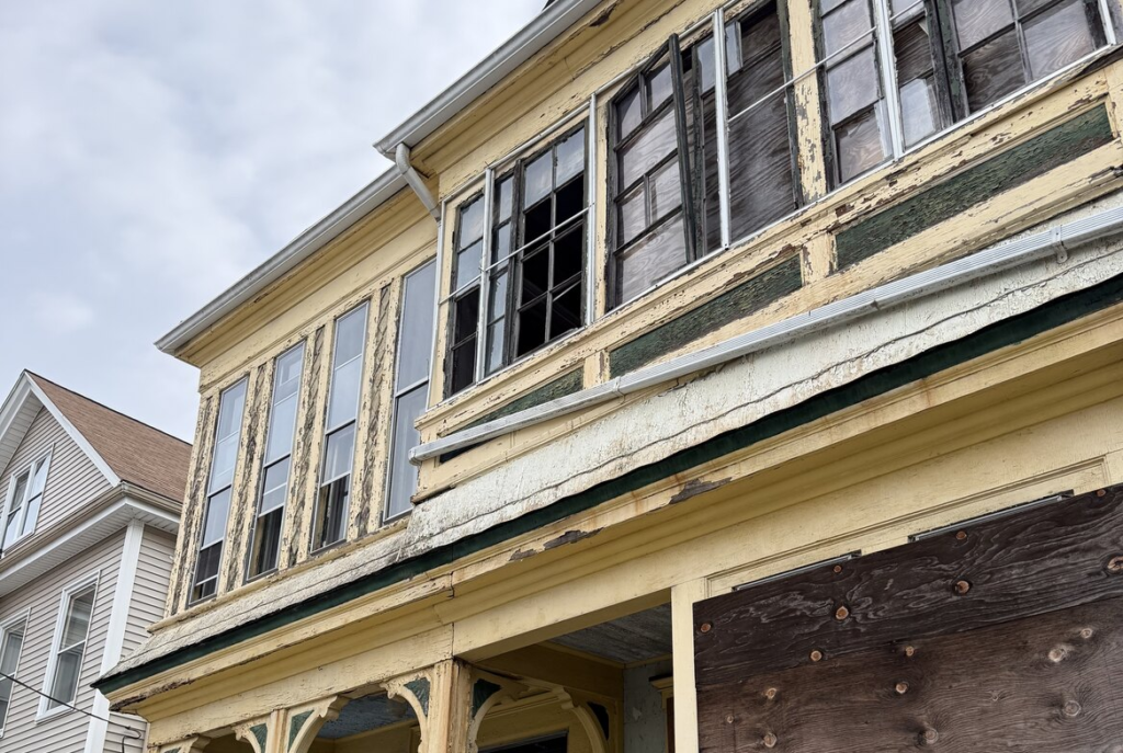 Yellow porch with peeling paint in southeastern Massachusetts
